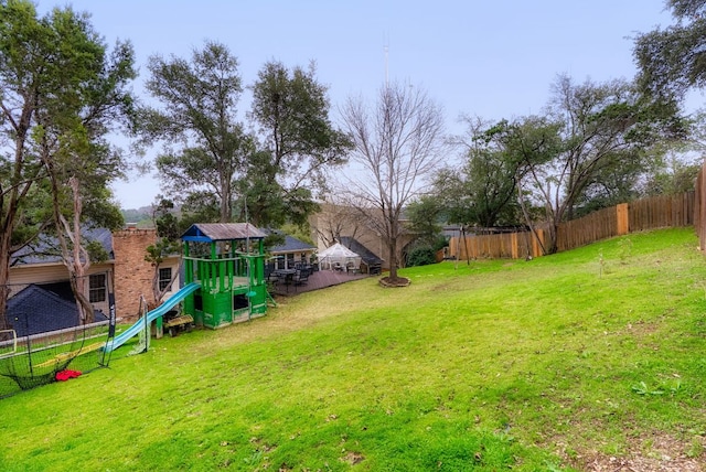 view of yard with a playground and fence