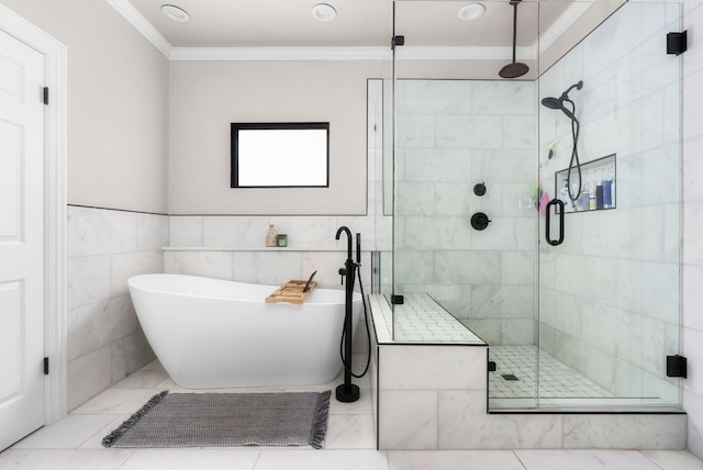 bathroom with a shower stall, tile walls, crown molding, and a freestanding tub