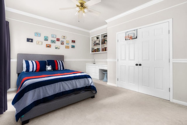 carpeted bedroom featuring a closet, baseboards, ceiling fan, and ornamental molding