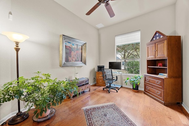 home office with ceiling fan, baseboards, lofted ceiling, and light wood-style floors