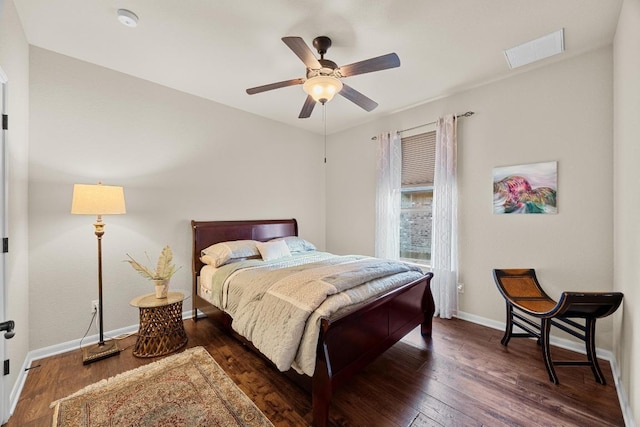 bedroom with ceiling fan, visible vents, baseboards, and wood finished floors