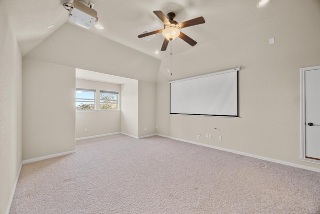 home theater featuring baseboards, ceiling fan, carpet flooring, and vaulted ceiling