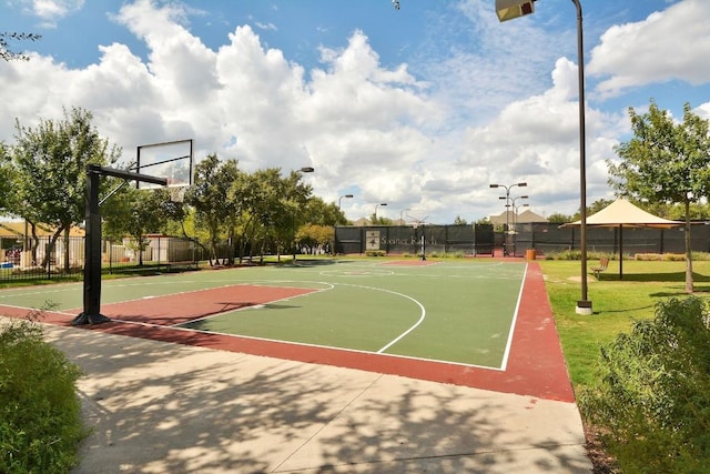 view of basketball court with community basketball court and fence