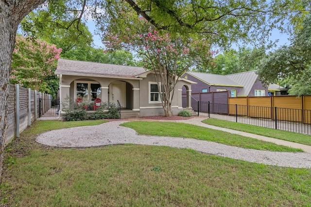 view of front of house featuring stucco siding, a porch, a front yard, and fence