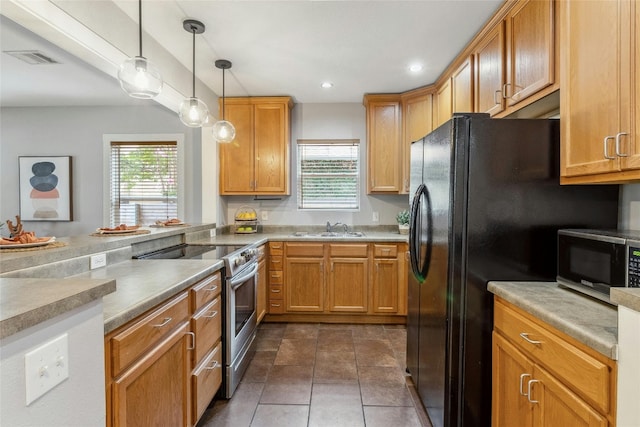 kitchen featuring a sink, pendant lighting, a healthy amount of sunlight, and stainless steel appliances