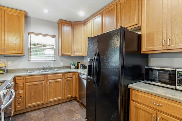 kitchen with recessed lighting, stainless steel appliances, light countertops, and a sink