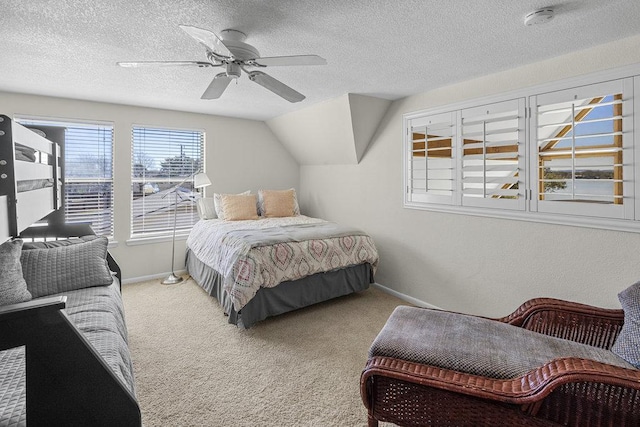 bedroom featuring vaulted ceiling, carpet floors, and a textured ceiling