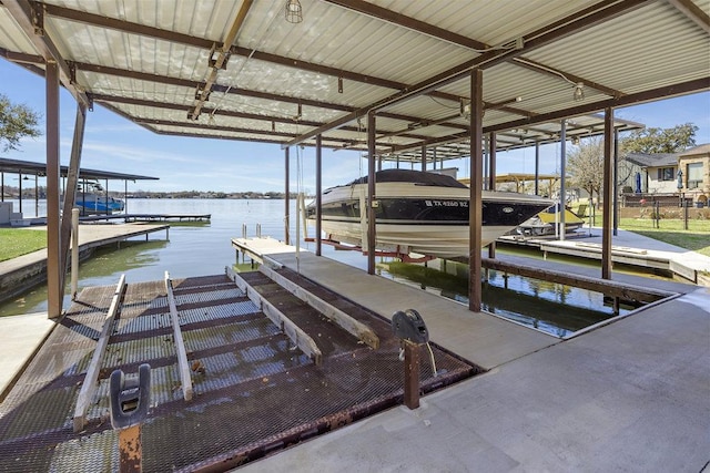 view of dock with boat lift and a water view