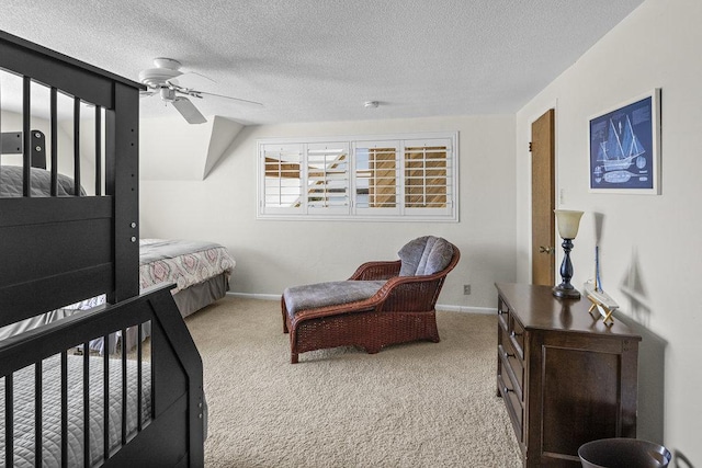 carpeted bedroom featuring a textured ceiling, baseboards, and a ceiling fan