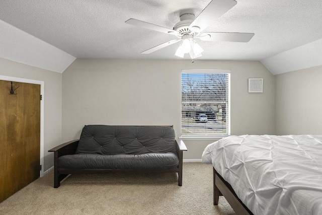 carpeted bedroom featuring baseboards, lofted ceiling, and a textured ceiling