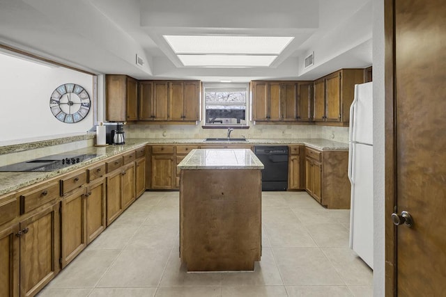 kitchen with tasteful backsplash, light tile patterned floors, black appliances, and a sink