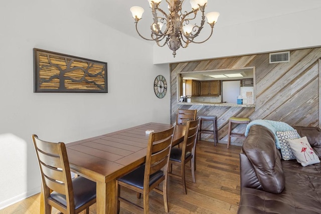 dining space with an inviting chandelier, visible vents, and light wood finished floors