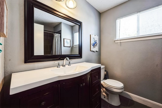 bathroom with vanity, a shower with curtain, baseboards, tile patterned floors, and toilet