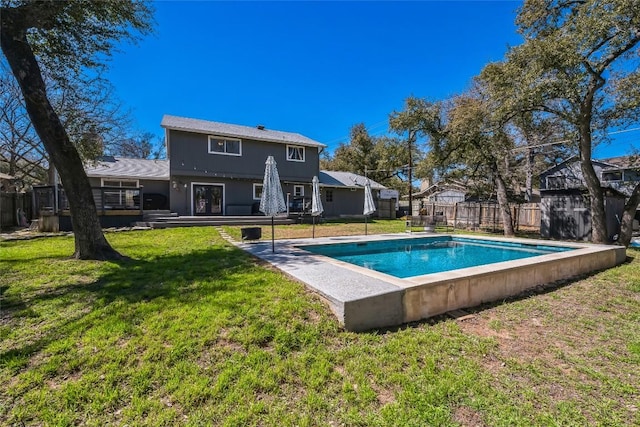 rear view of property with a yard, a fenced backyard, a fenced in pool, and a deck