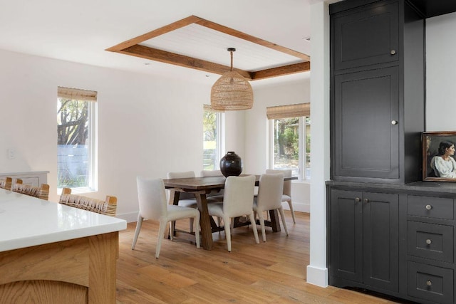 dining area with baseboards and light wood finished floors