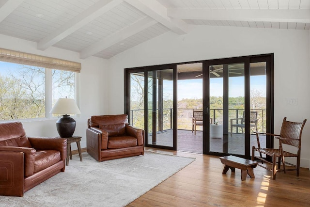 living area featuring lofted ceiling with beams, french doors, and wood finished floors