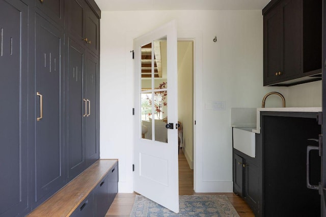 mudroom featuring baseboards and wood finished floors