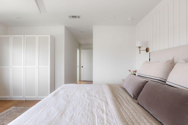 bedroom featuring visible vents and light wood-style flooring