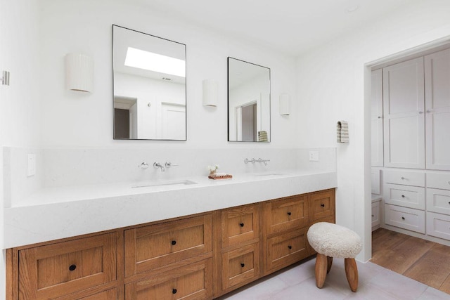 bathroom featuring double vanity and a sink