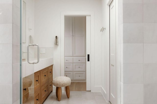 bathroom with tile patterned flooring and walk in shower