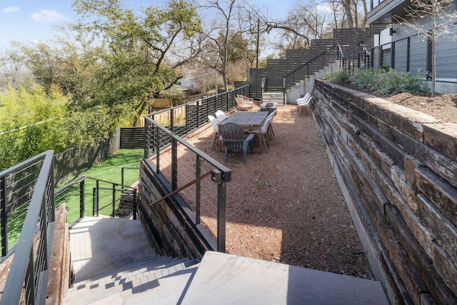 view of yard featuring stairs and fence