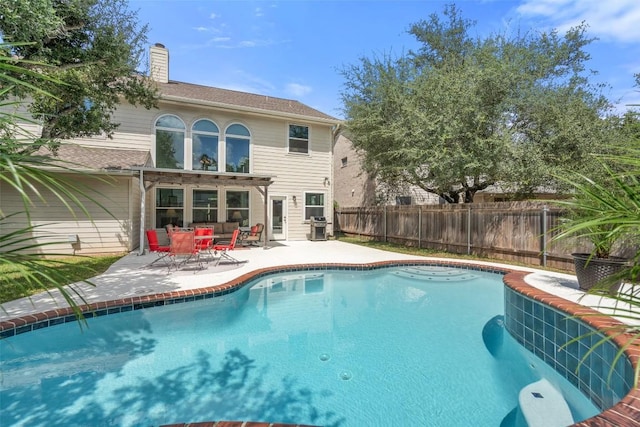 view of swimming pool featuring a fenced in pool, a grill, a patio, and fence