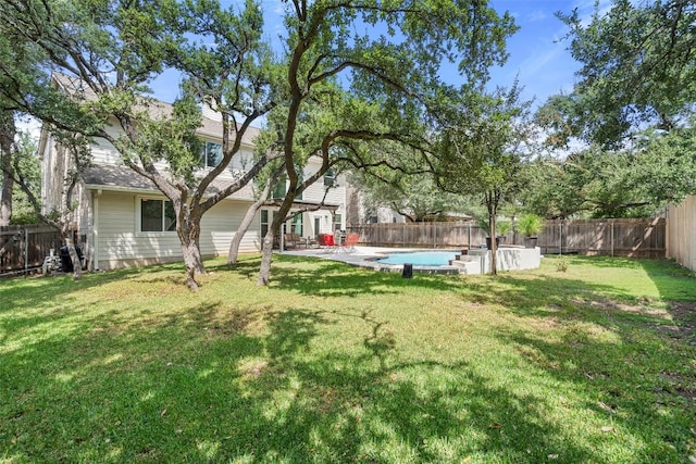 view of yard with a fenced in pool, a patio, and a fenced backyard