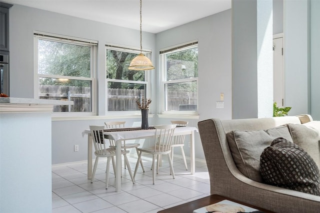 dining area with light tile patterned floors and baseboards