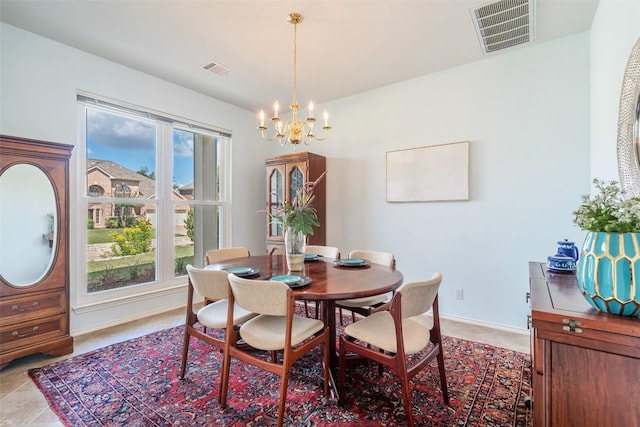 dining area featuring a notable chandelier, visible vents, plenty of natural light, and baseboards