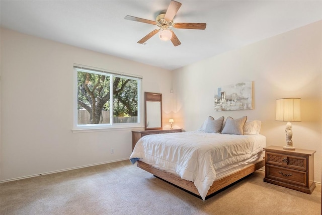 carpeted bedroom with baseboards and ceiling fan