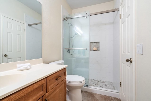 full bathroom with vanity, toilet, and a stall shower