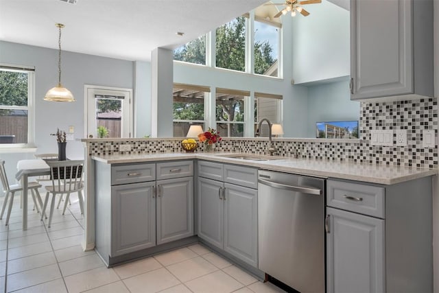 kitchen with dishwasher, light countertops, gray cabinets, and a wealth of natural light