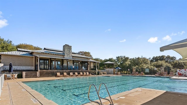 pool with fence and a patio area