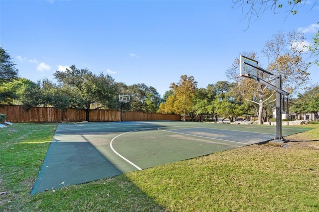 view of sport court featuring community basketball court, a yard, and fence