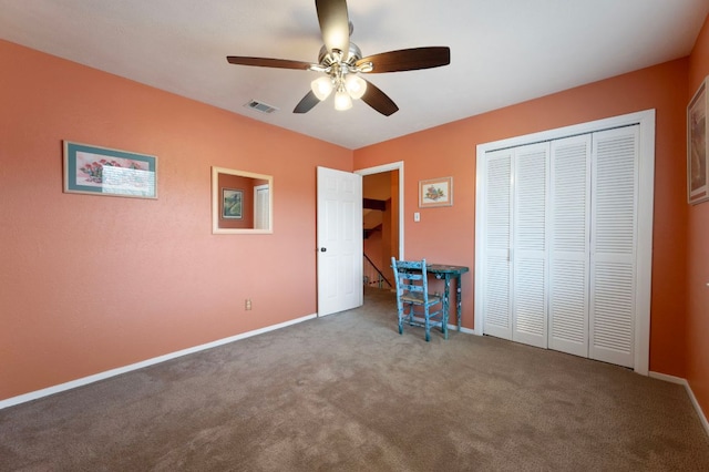 unfurnished bedroom featuring visible vents, a ceiling fan, a closet, carpet flooring, and baseboards