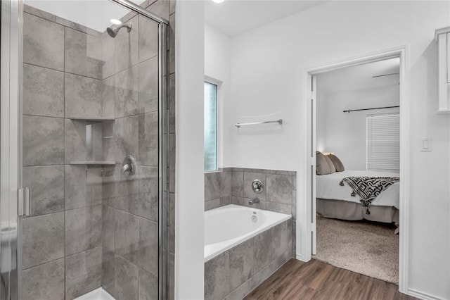 full bath with a garden tub, a shower stall, wood finished floors, and ensuite bathroom