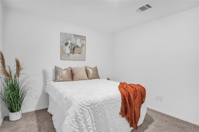 carpeted bedroom featuring baseboards and visible vents