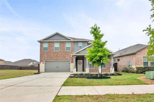 craftsman-style home with brick siding, an attached garage, fence, a front yard, and driveway