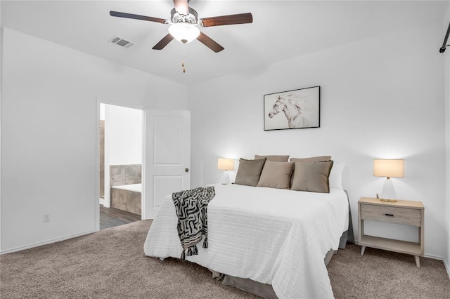 bedroom featuring carpet, visible vents, ensuite bathroom, and ceiling fan