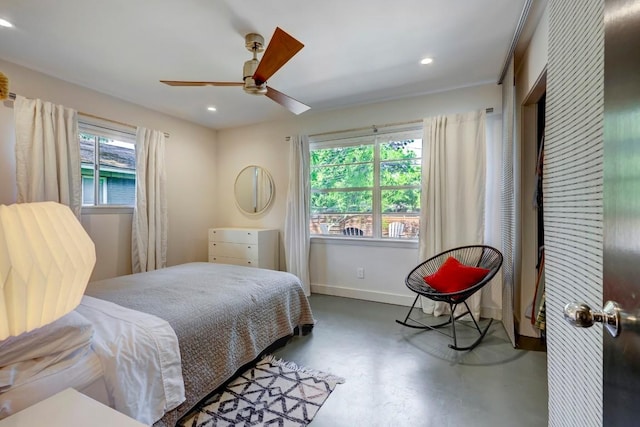 bedroom featuring a ceiling fan, recessed lighting, finished concrete flooring, and baseboards