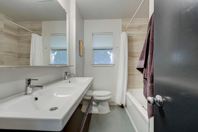 bathroom featuring a sink, toilet, shower / bath combo, and double vanity