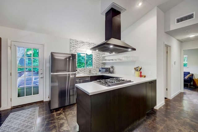 1908 Fairlawn Ln, Austin, TX 78704 - kitchen featuring stainless steel appliances, wall chimney exhaust hood, a peninsula, backsplash, and light countertops