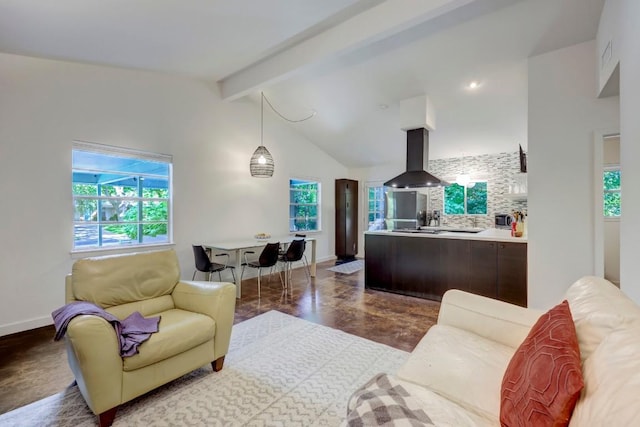 living area with lofted ceiling with beams and baseboards