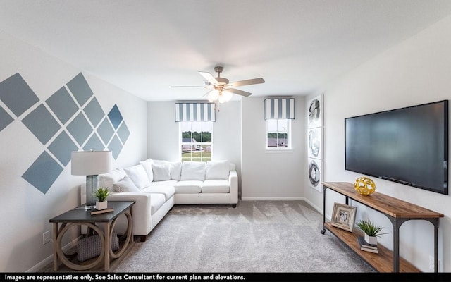 living room featuring baseboards, carpet, and ceiling fan