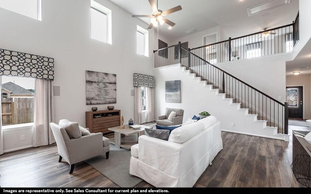 living room featuring stairway, wood finished floors, and a ceiling fan