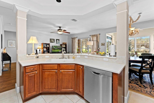 kitchen with a sink, visible vents, stainless steel dishwasher, and decorative columns