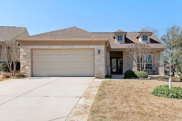 view of front of home with concrete driveway, a garage, stone siding, and stucco siding