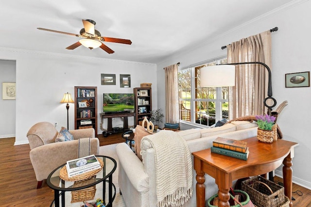 living room with baseboards, wood finished floors, a ceiling fan, and ornamental molding