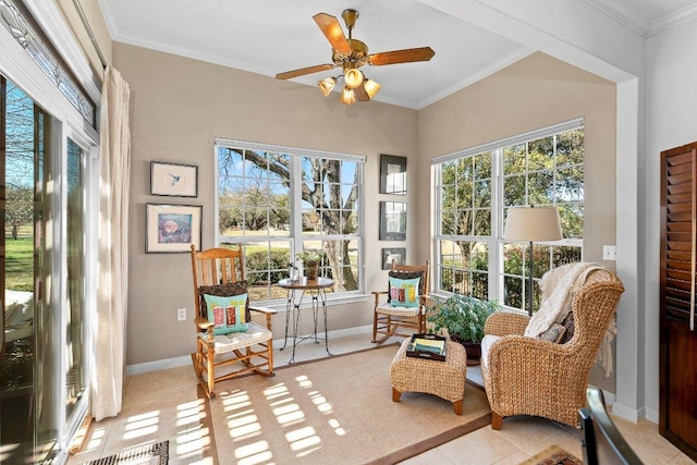 sunroom with a healthy amount of sunlight, visible vents, and ceiling fan