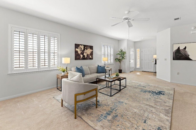 living area featuring a ceiling fan, carpet, visible vents, and baseboards